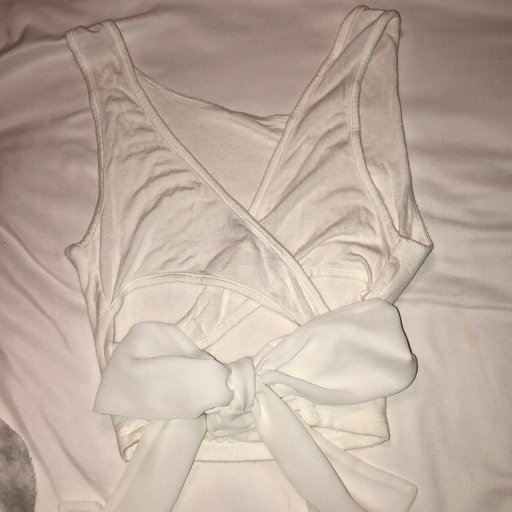 i am selling a white crop tank top with a bow.